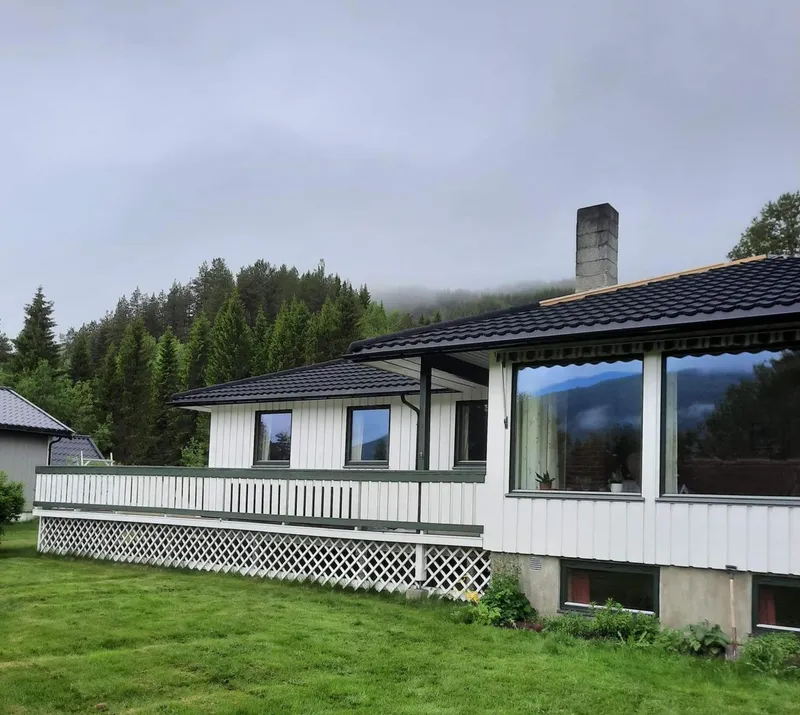 Hvit bolig med overbygd uteplass